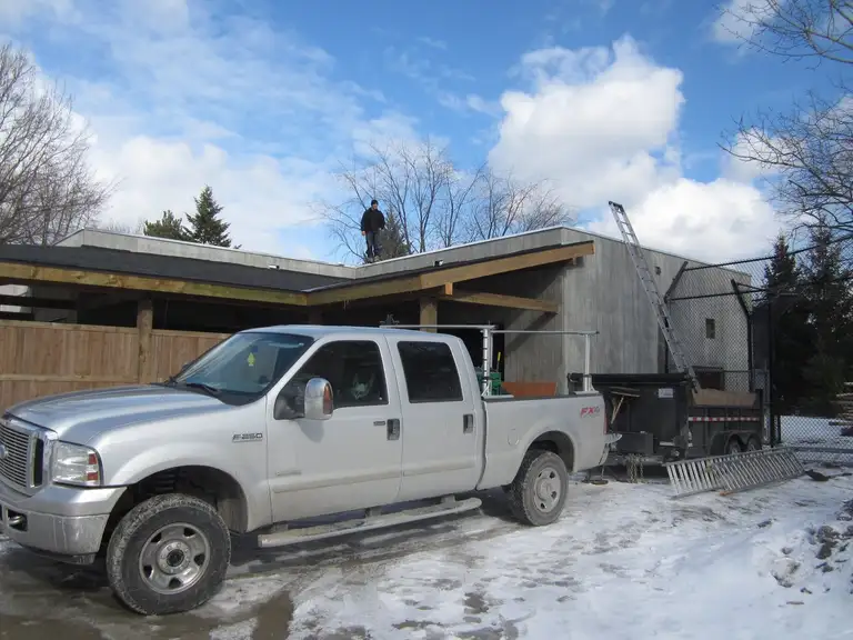 A Lanigan's Contracting crew member working on a roof